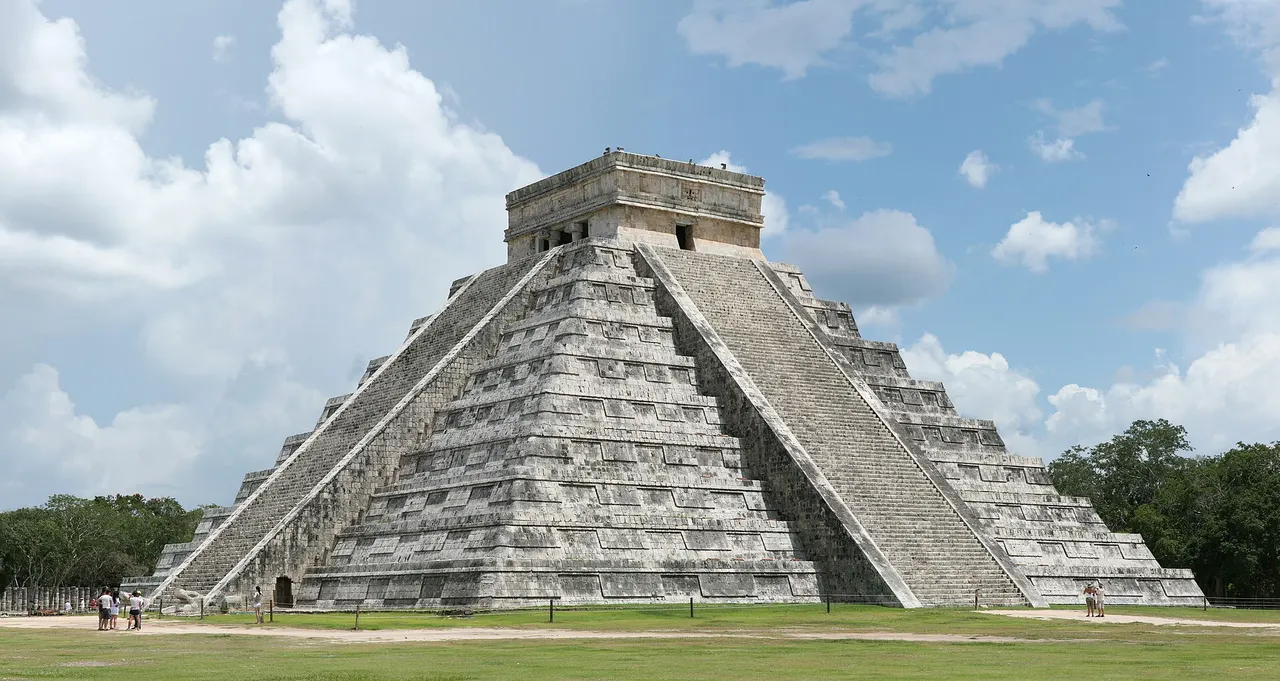 The stepped pyramid of El Castillo, the Temple of Kukulcán, at Chichén Itzá under a blue sky