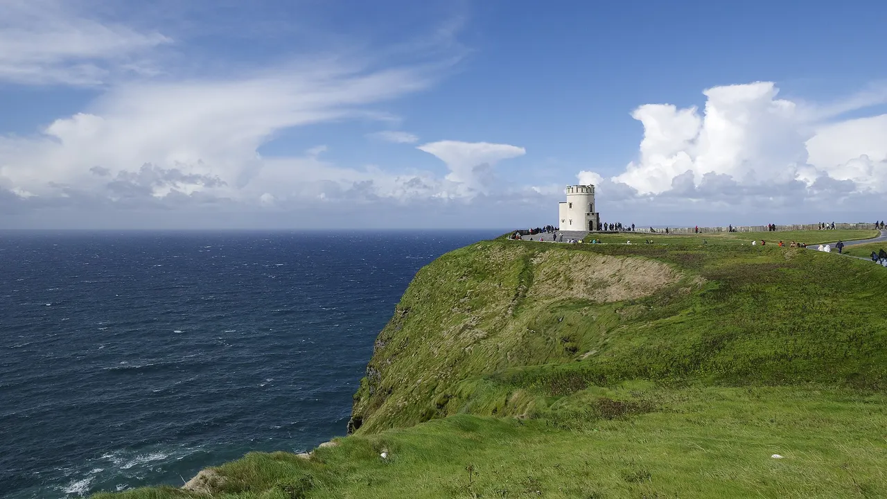 Green clifftops and O'Brien's Tower above the Atlantic at the Cliffs of Moher