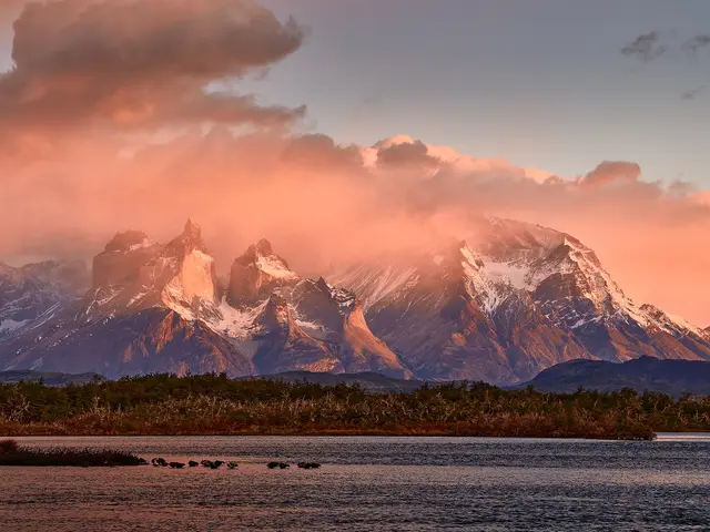The dark-capped granite peaks of the Cuernos del Paine above a lake in Torres del Paine National Park