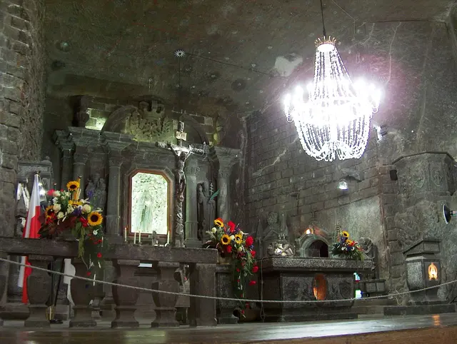 The altar of St Kinga's Chapel, carved from rock salt, under a salt crystal chandelier in the Wieliczka Salt Mine