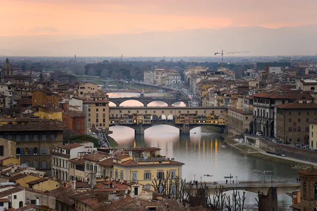 The Ponte Vecchio and the bridges over the River Arno at sunset, seen from Piazzale Michelangelo above Florence