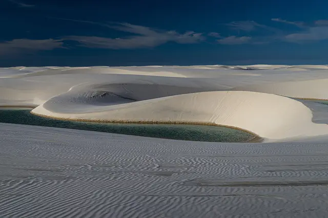 White sand dunes and a rainwater lagoon in Lençóis Maranhenses National Park in north-eastern Brazil
