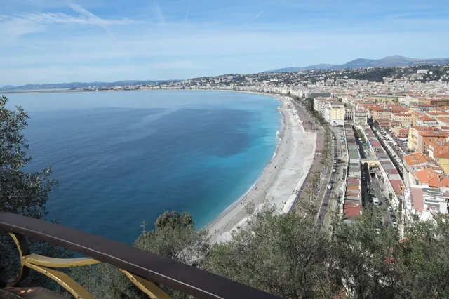 The sweeping Baie des Anges in Nice, with the pebble beach and Promenade des Anglais curving along the turquoise sea
