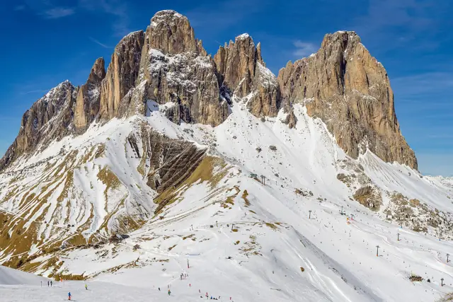 The jagged Langkofel (Sassolungo) group rising above snowy slopes near the Sella Pass in the Dolomites