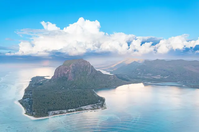 Aerial view of the Le Morne peninsula and its mountain surrounded by a turquoise lagoon in Mauritius