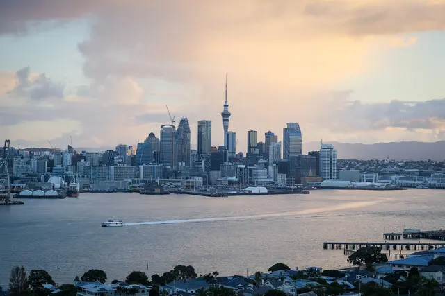 The Auckland city skyline and Sky Tower across the Waitematā Harbour at sunset
