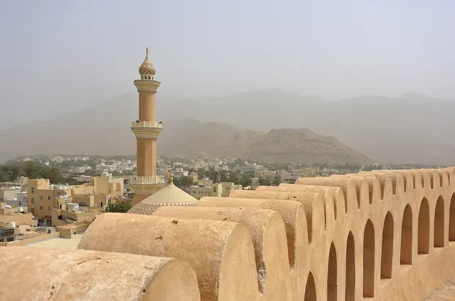 The sandstone towers and walls of Nizwa Fort in Oman