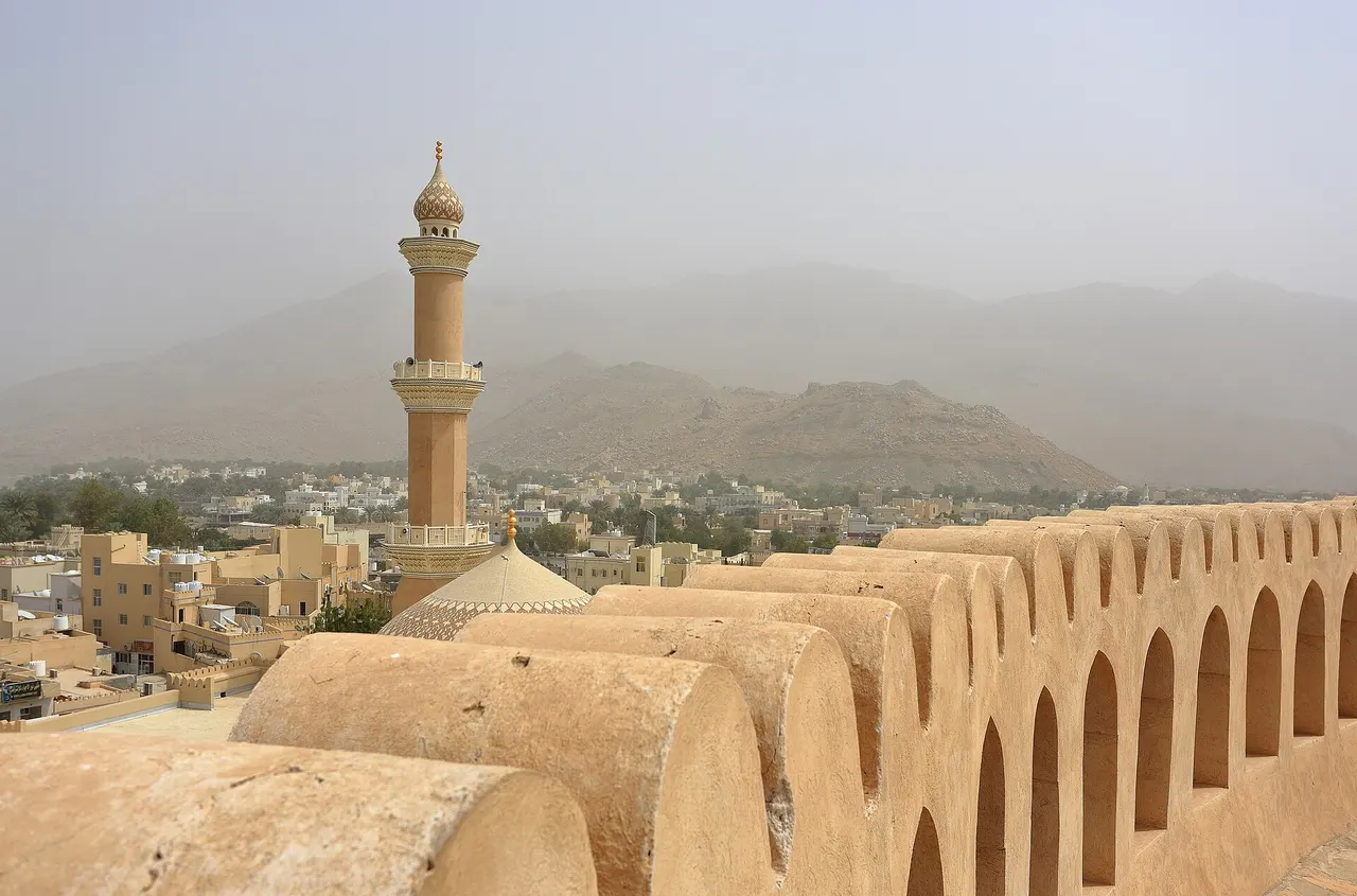 The sandstone towers and walls of Nizwa Fort in Oman