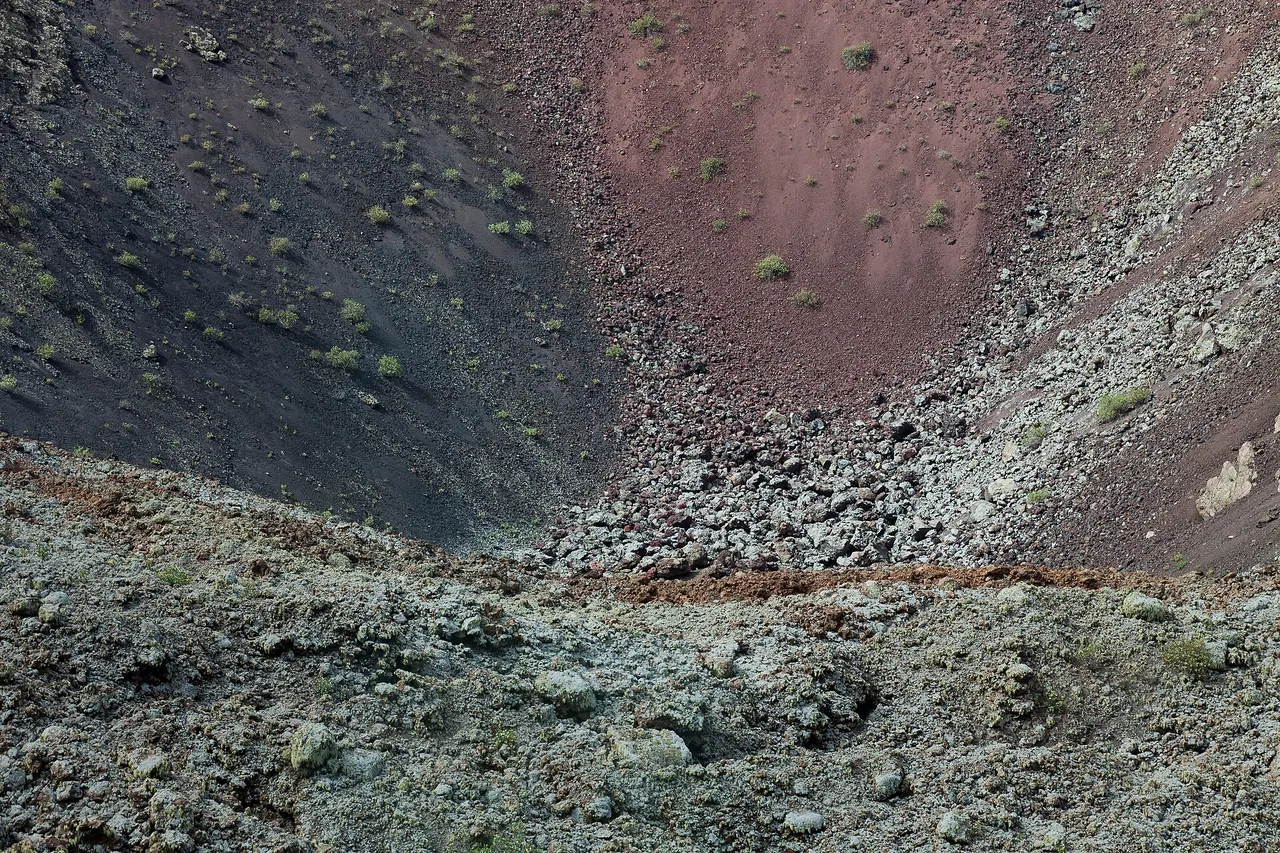 A red and grey volcanic crater in Timanfaya National Park on Lanzarote