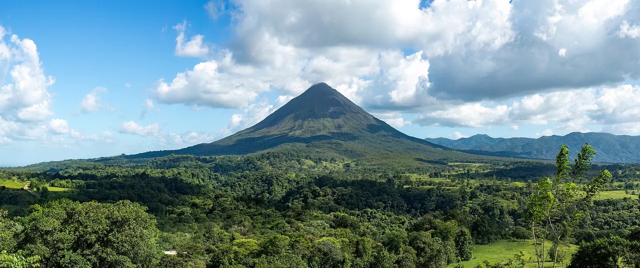 The cone of Arenal Volcano rising above rainforest in Costa Rica
